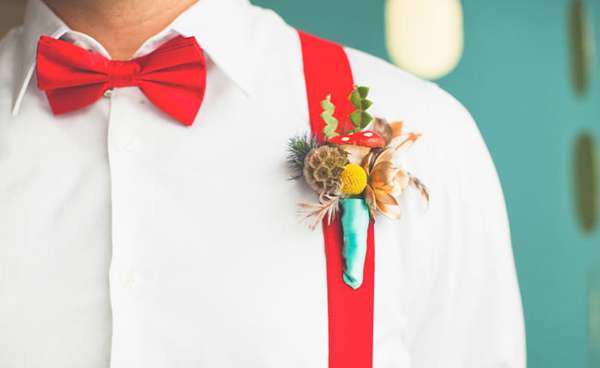 Bright red bowtie matching suspenders a coloful fun boutonniere 